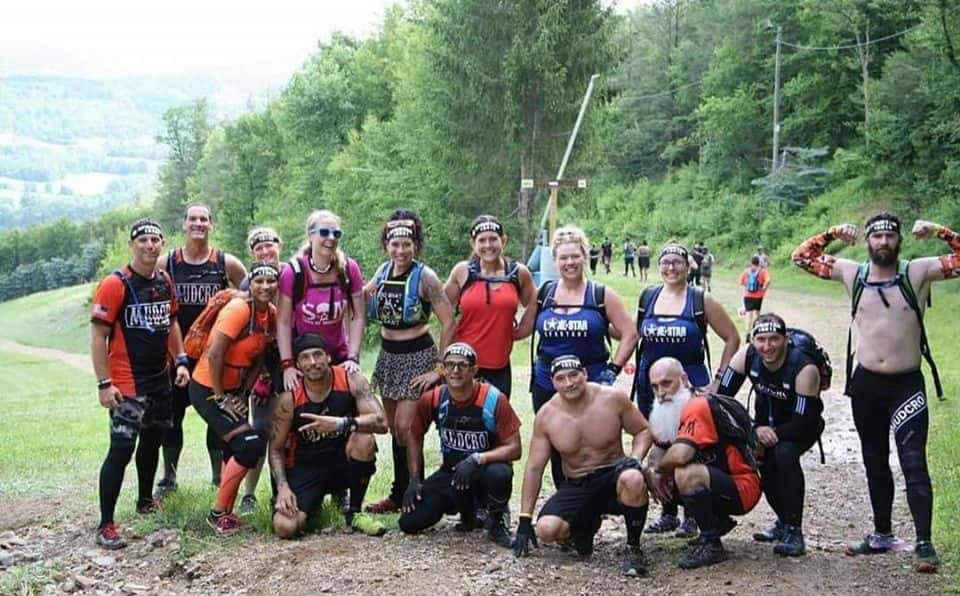 Group of racers come together for a team photo on the Blue Mountain Trails during Spartan Trifecta Weekend.