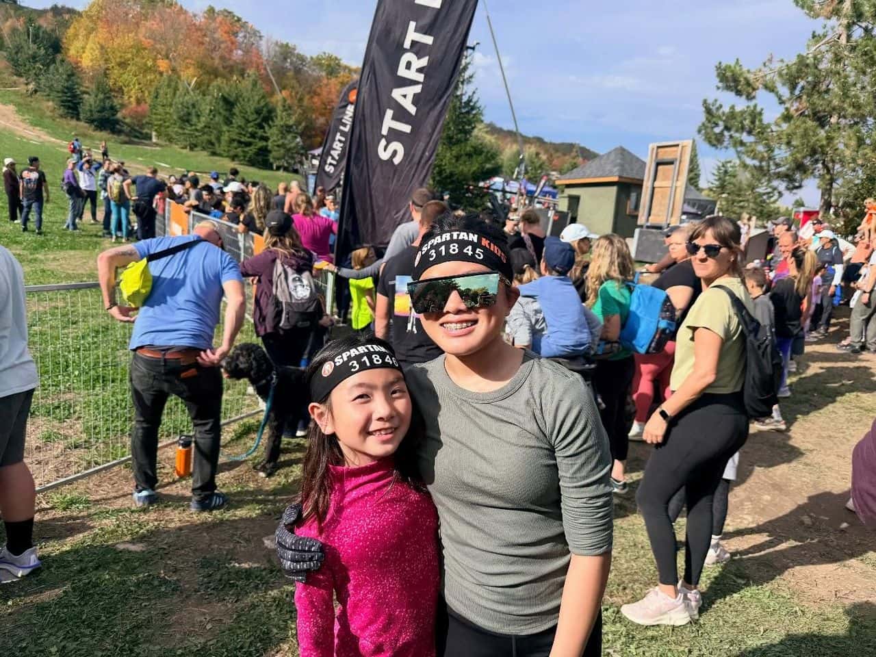 Mom and daughter smile and high at the base of Blue Mountain at the Spartan Trifecta Weekend