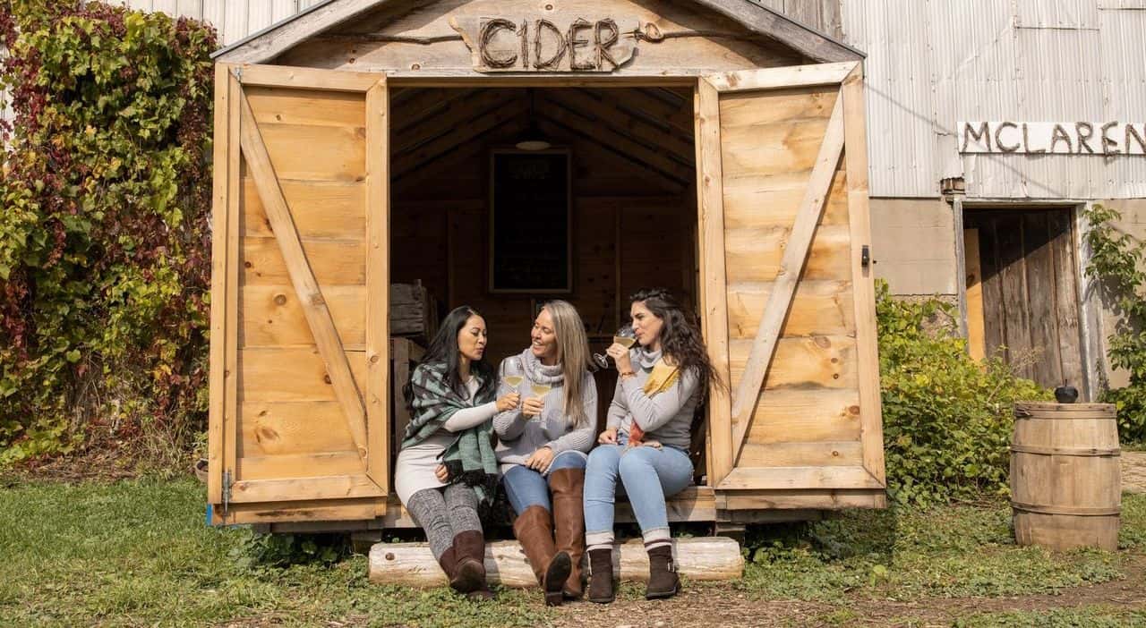 A photo of three women sipping cider at Grey and Gold.