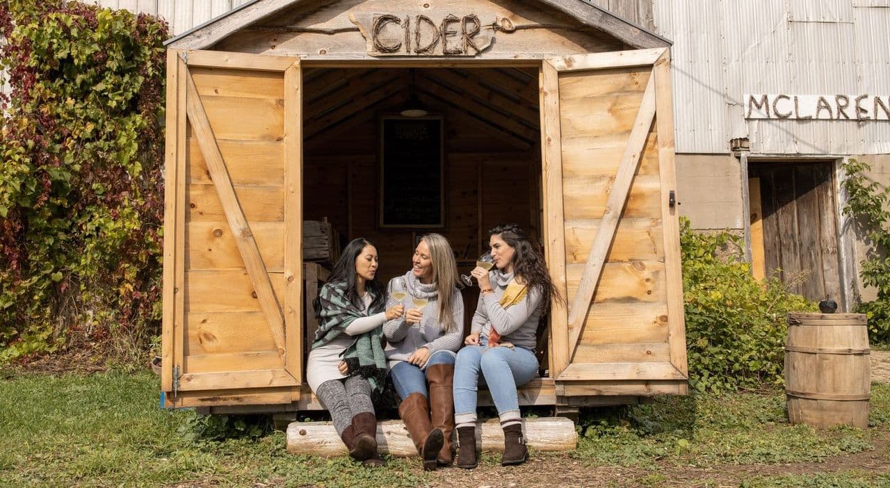 A photo of three women sipping cider at Grey and Gold.