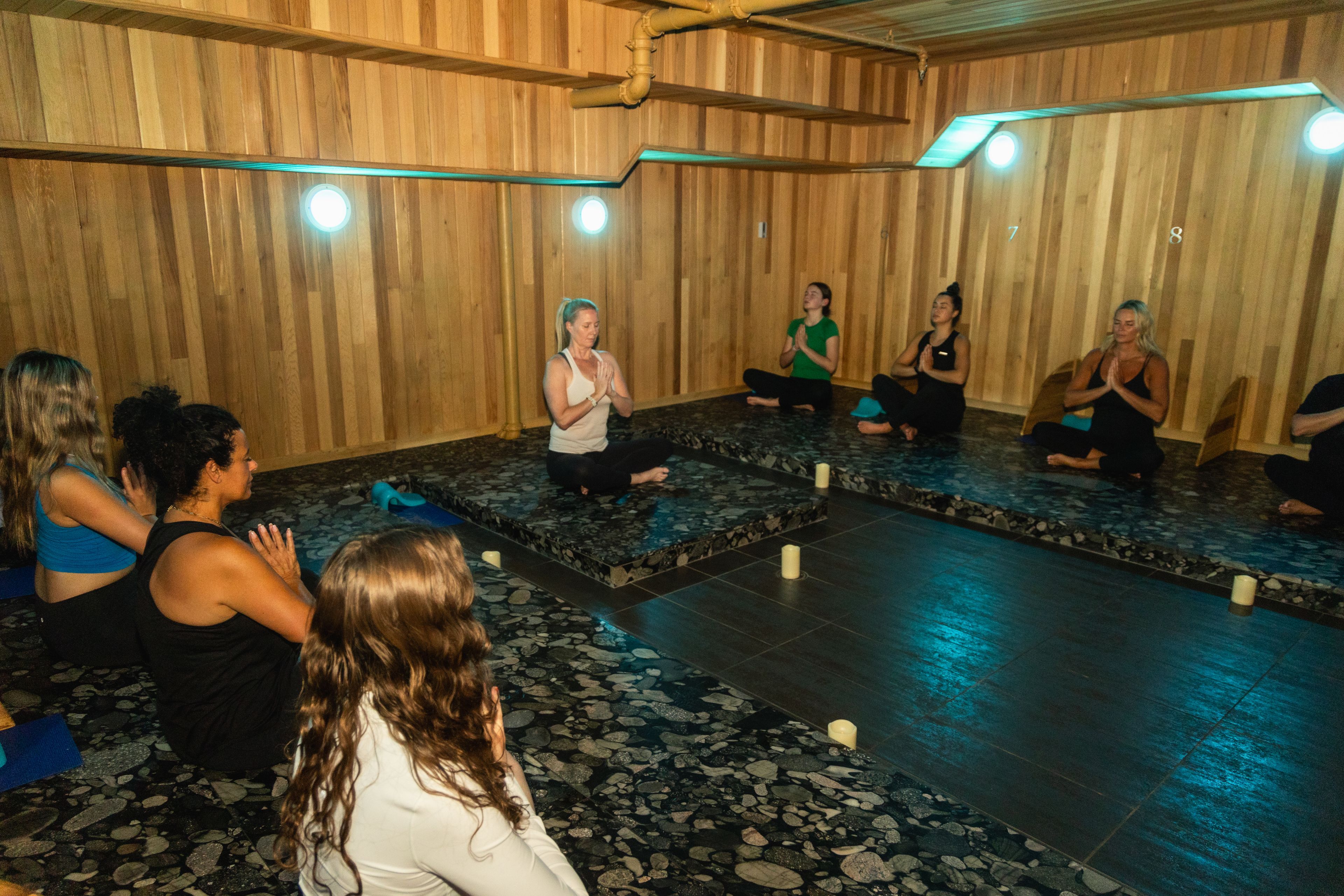 A group of ladies sitting in the lotus pose during a yoga session at iwa Spa at Blue Mountain Village