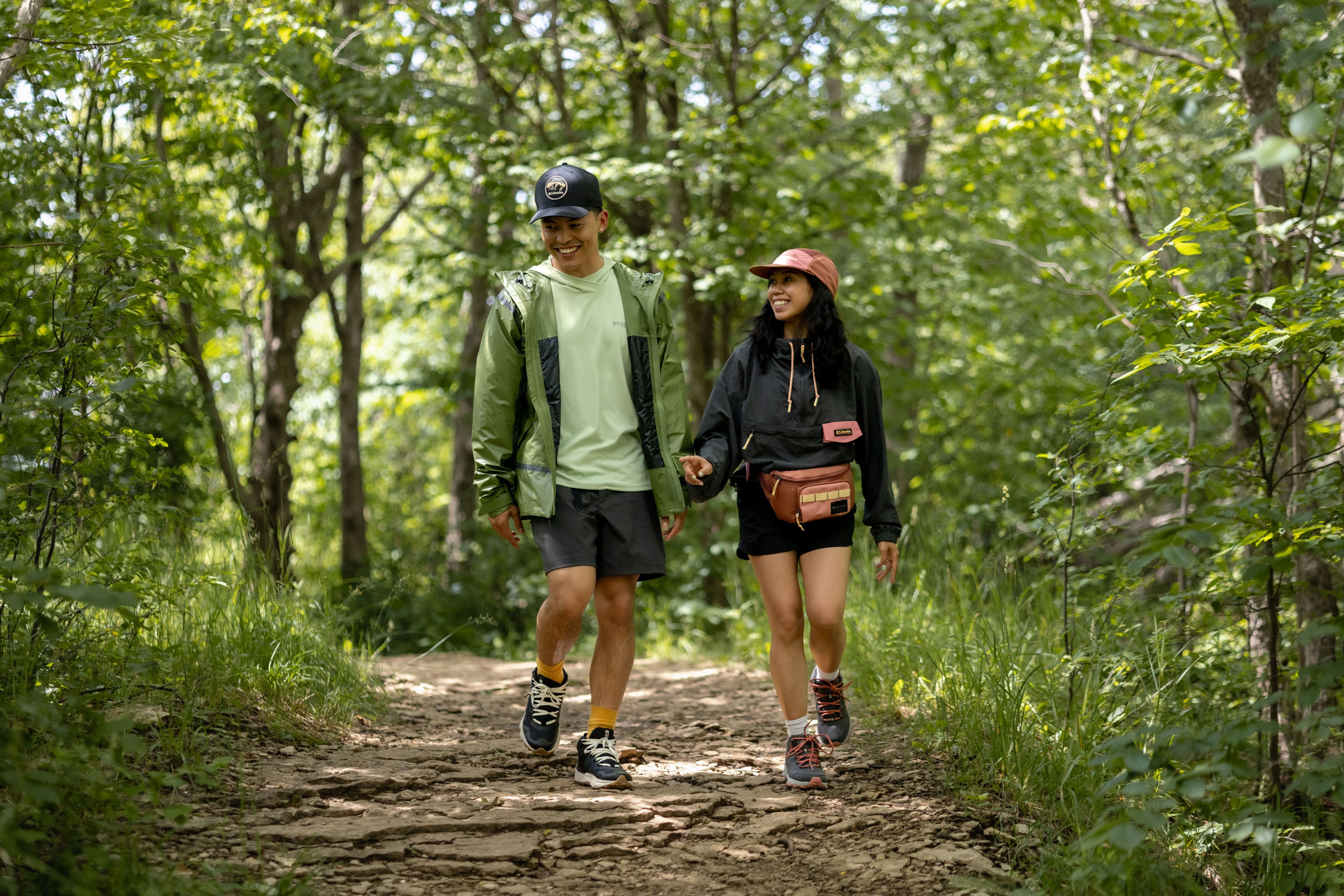 Couple walking along the Blue Mountain Resort Hiking Trails hand in hand on a warm afternoon.